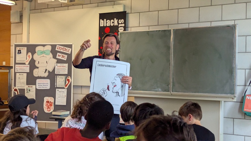 Jens Schumacher mit Bildtafel zu einem Rätsel
